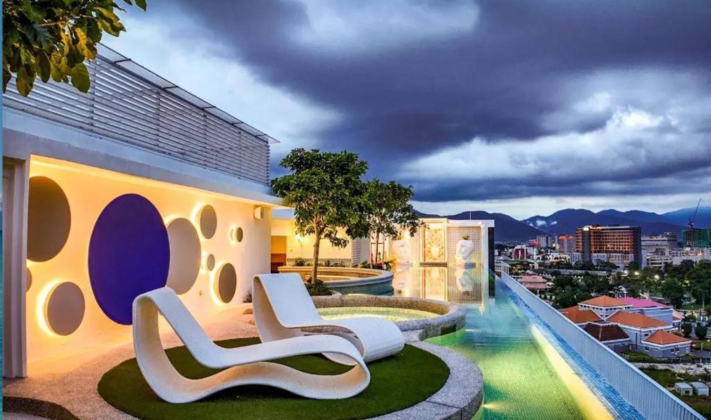 a building with two lounge chairs on the roof at Stallionz by KLIQ in Ipoh