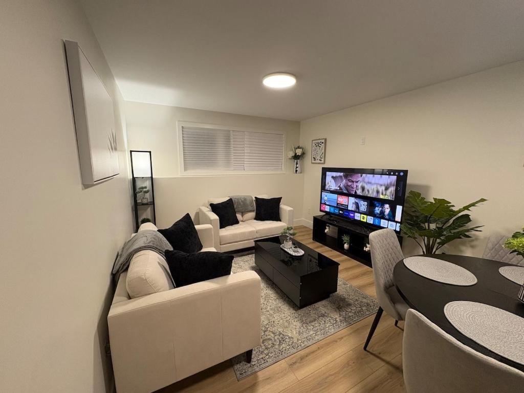 a living room with a couch and a tv at Lovely Two-Bedroom APT at Kenmount Terrace in St. John's