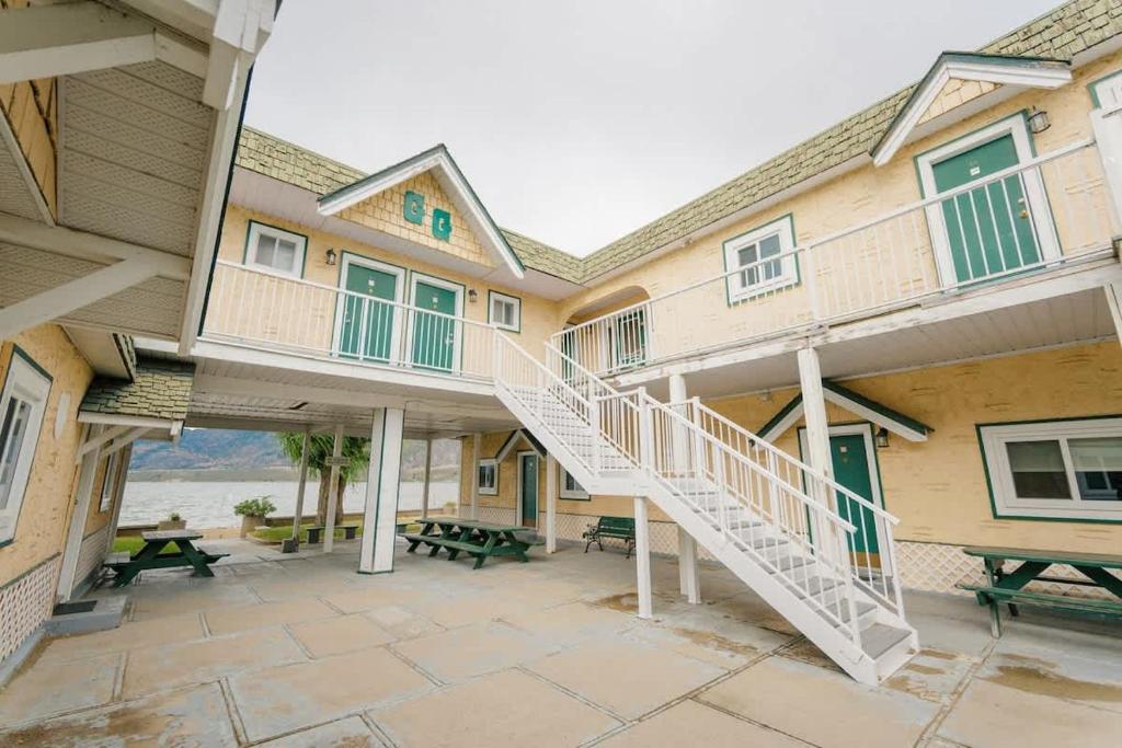 a building with a staircase and a patio at 1 BR Suite 9 at Green Gables Resort in Osoyoos