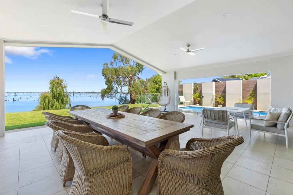 a dining room with a table and chairs at Woodbine Waters Lakehouse in Yarrawonga