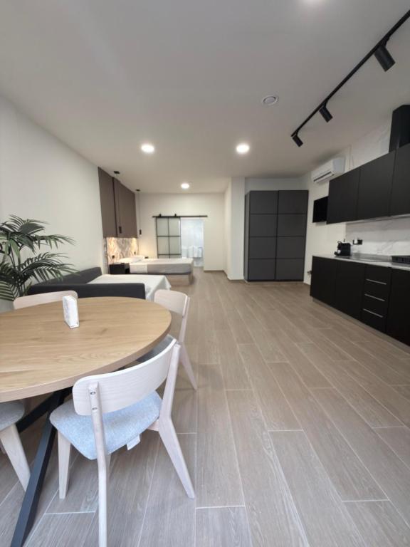 an office with a table and chairs and a kitchen at Apartamentos Nuevos en Valencia in Valencia