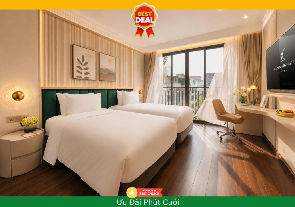 a hotel room with two beds and a tv at Luxeden Signature hotel in Hanoi