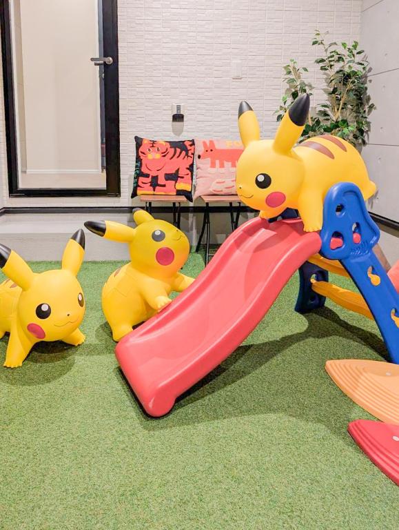 a group of toy pikachu playing on a slide at Encounter Hakata in Fukuoka