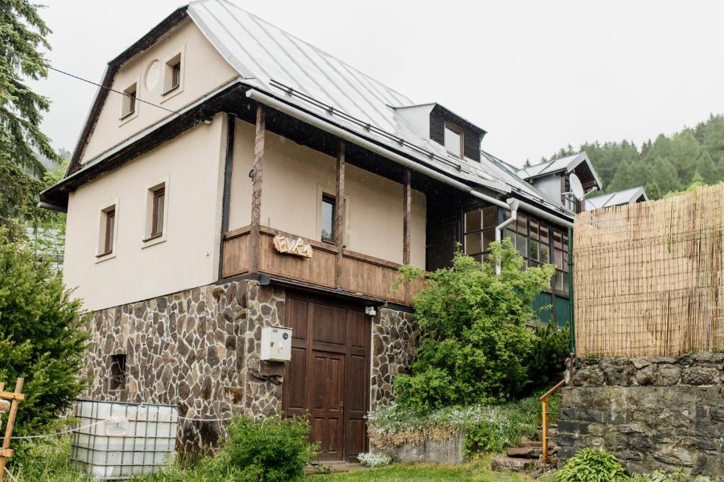 an old stone house with a wooden door at Mountain Chalet Donovaly with Sauna & Jacuzzi in Donovaly