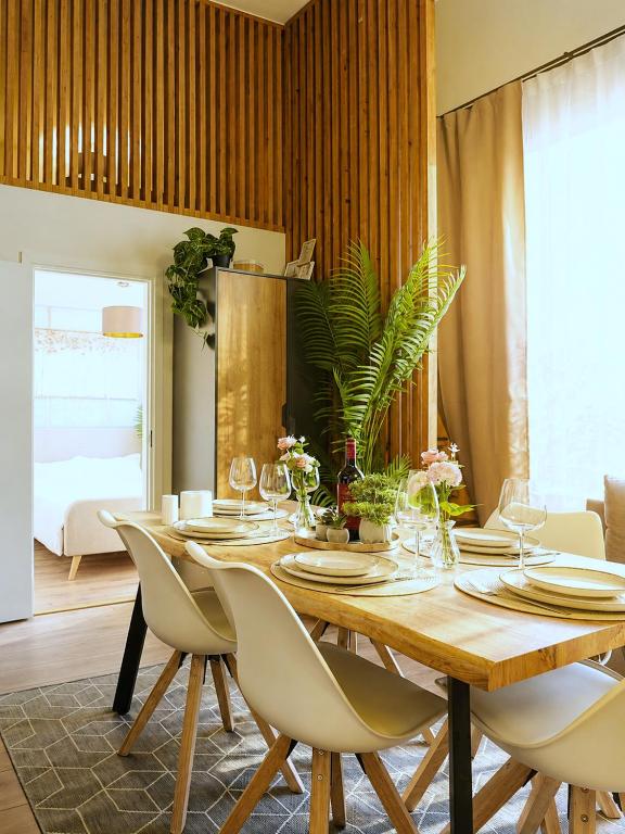 a dining room with a wooden table and chairs at Cofy Rentals - old town, quiet area, air-conditioning, free parking, 24-7 express check-in-out, close to green parks, everything you need for living in Pärnu