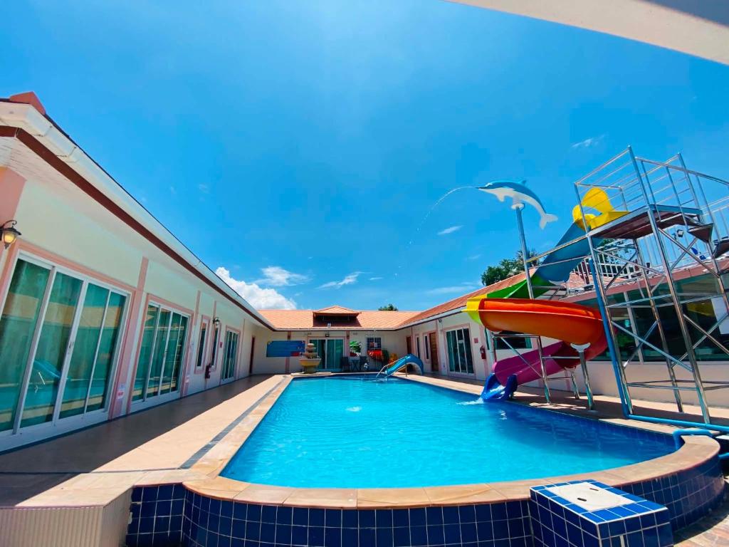 a pool with a slide and a boat on top of a building at Home Hakim in Cha Am