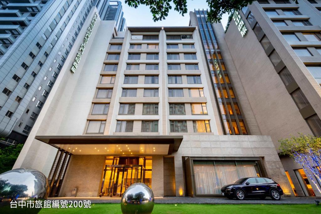 a building with a car parked in front of it at Hung's Mansion in Taichung