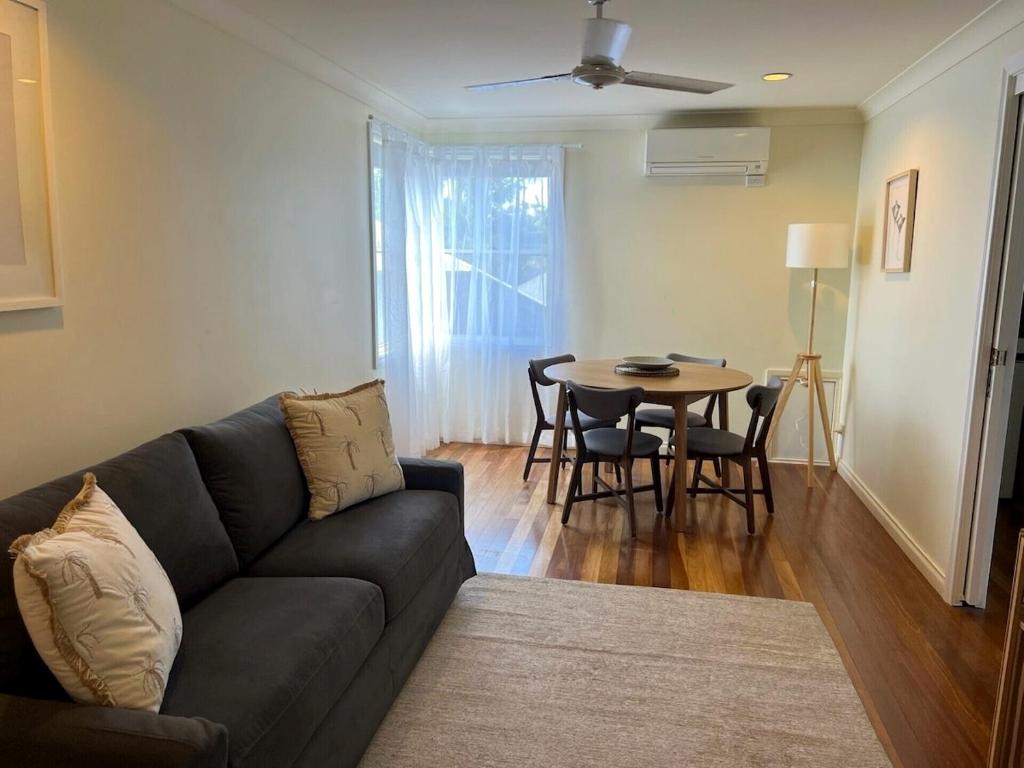 a living room with a couch and a table at The Arabella Motel in Wollongbar