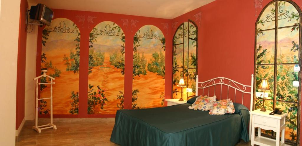 Łóżko lub łóżka w pokoju w obiekcie Hotel Las Rosas