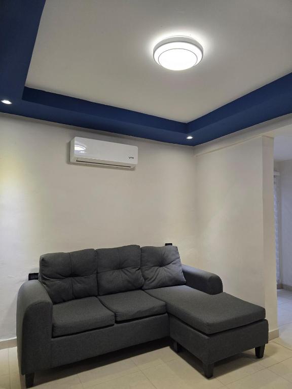 a living room with a couch and a ceiling at Apartment with separate parking in Heroica Nogales