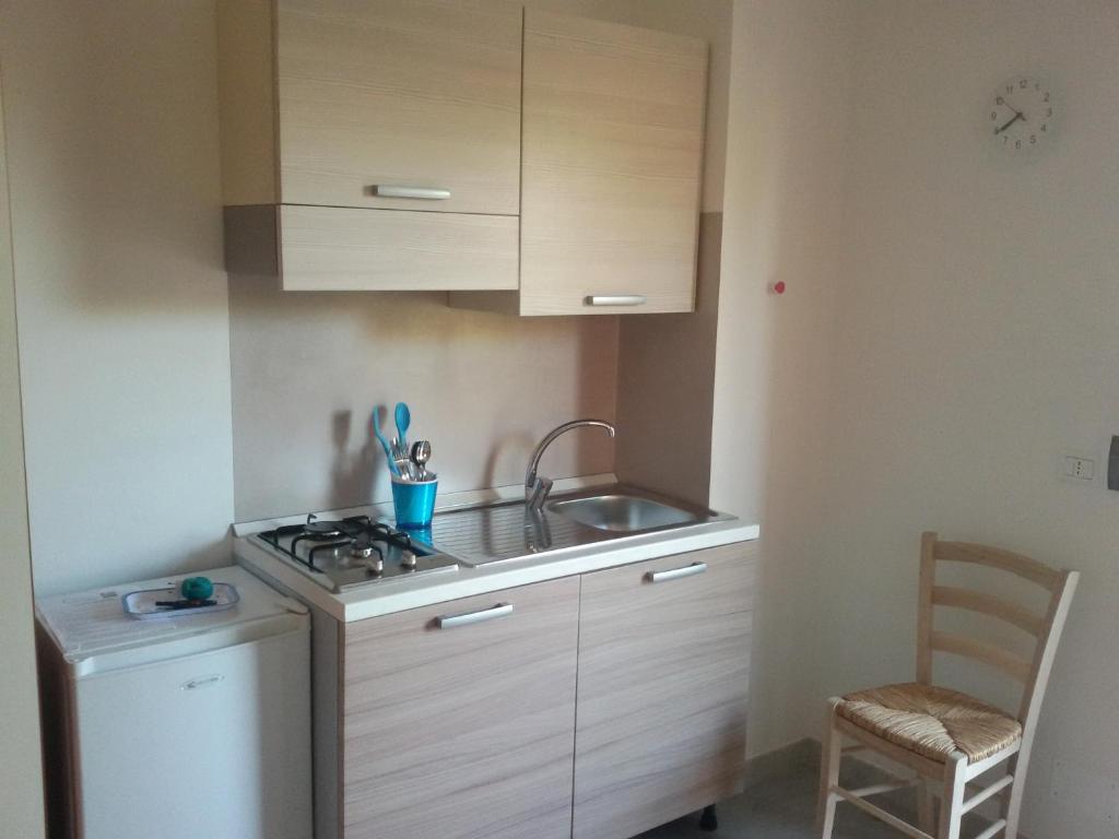 a small kitchen with a sink and a stove at Green Garden Eco-Holiday in Vieste