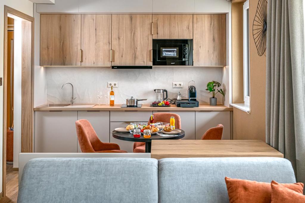 a kitchen with a table and chairs in a room at Lazuli Apartment in Hegykő