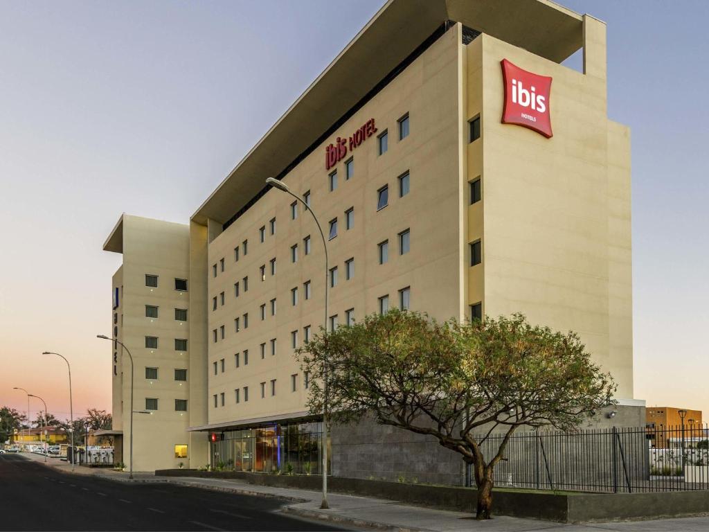 a building with a big sign on the side of it at ibis Calama in Calama