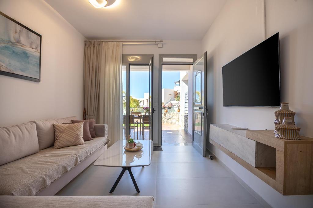 a living room with a couch and a tv at Antonias Serenity in Loutra