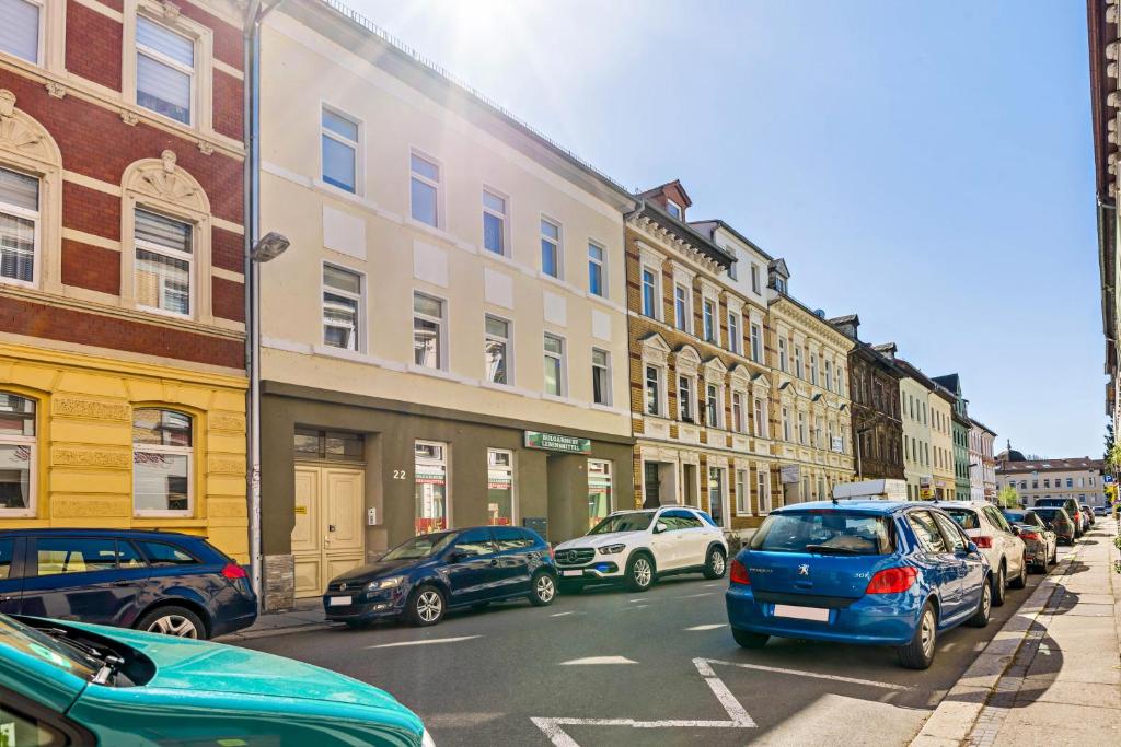 a busy city street with cars parked on the street at Haus Gera in Gera