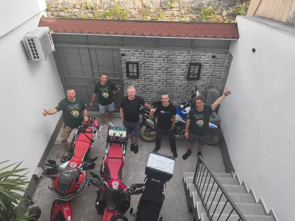 a group of men standing in front of motorcycles at Apartments Ajla in Mostar