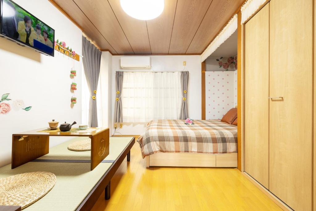 a small bedroom with a bed and a table at 大津屋a in Yokohama