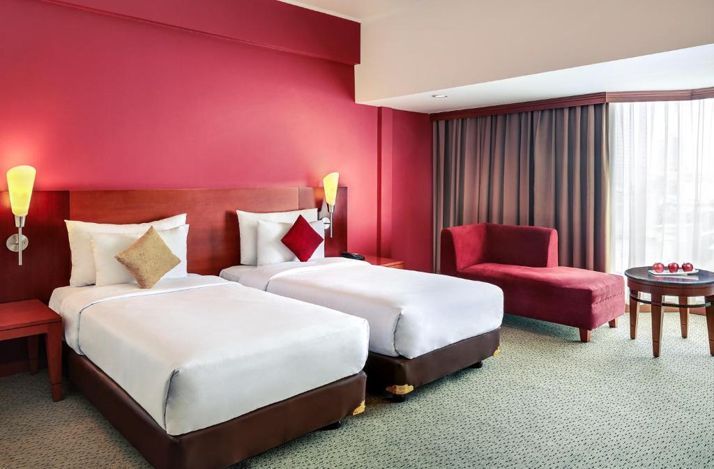 Postel nebo postele na pokoji v ubytování Mercure Jakarta Kota