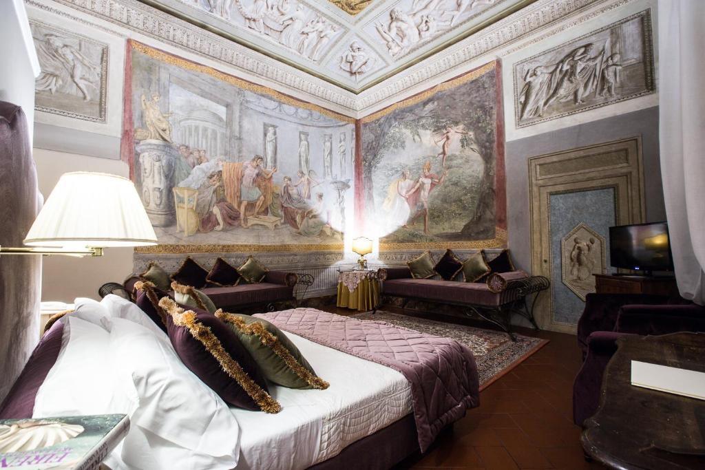a bedroom with a painting on the wall and a bed at Hotel Burchianti in Florence