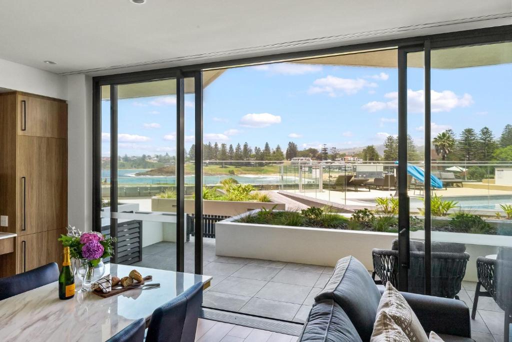 an open living room with a view of the ocean at Kove Apartment - G06 in Kiama
