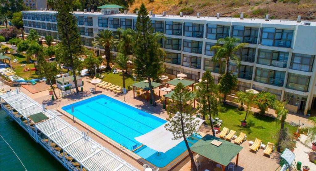 an aerial view of a resort with a swimming pool at Ron Beach Hotel in Tiberias