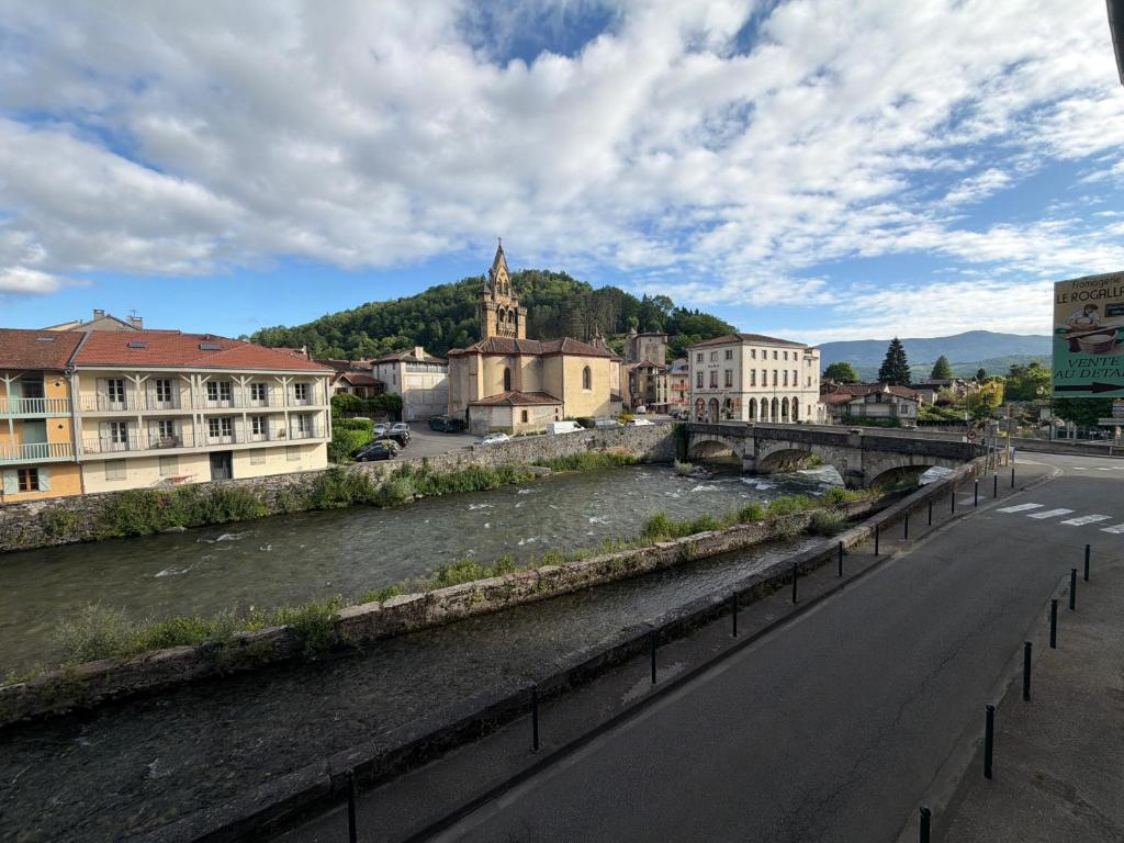 a bridge over a river in a city at Entre Rivière et Sommets in Seix