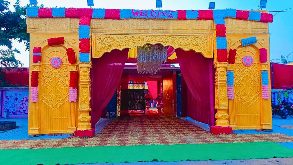 a colorful entrance to a building with a stage at Prem Garden in Bhiwāni