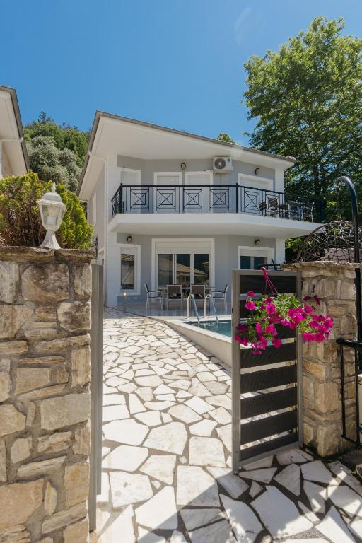 a villa with a swimming pool and a house at Diamanti Villa, Pool & Barbecue in Skala Potamias