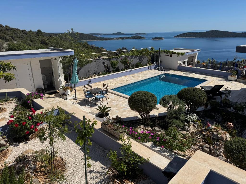 a villa with a swimming pool and a garden at Panorama Sevid in Sevid