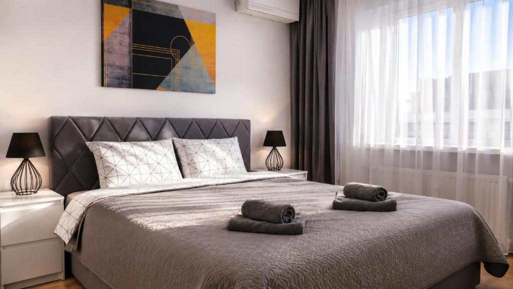 a bedroom with a bed with two towels on it at K-49 prie Jūros in Klaipėda