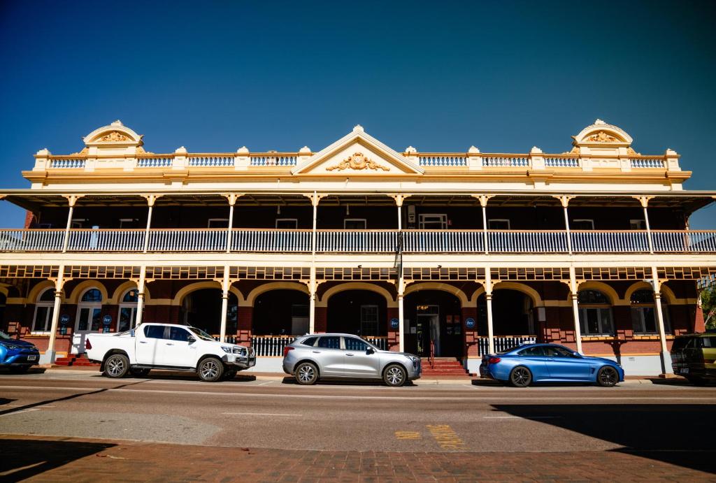 a large building with cars parked in front of it at Rec Toodyay Hotel in Toodyay