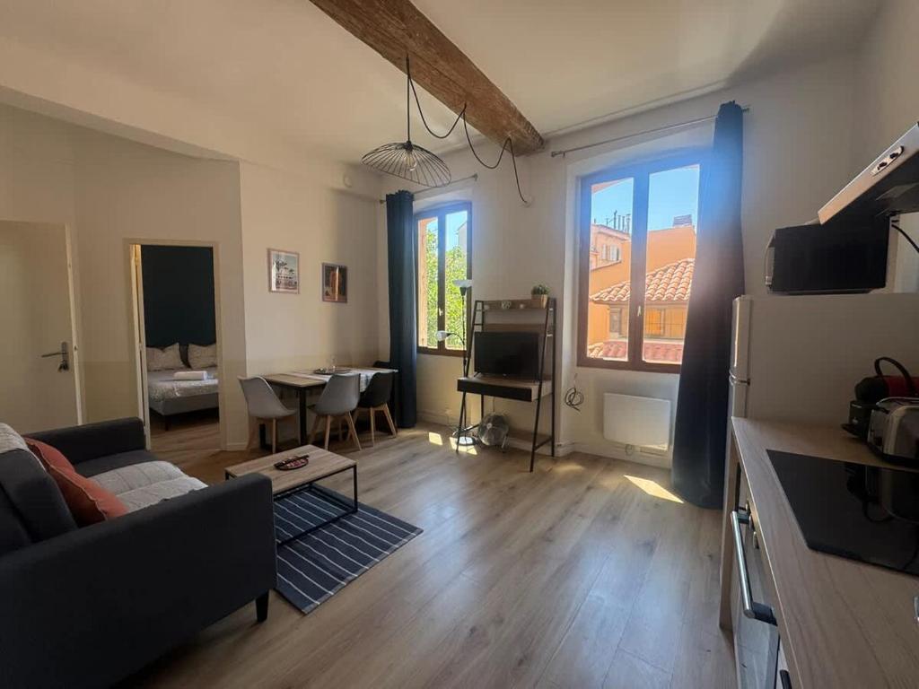 a living room with a couch and a table at Le Nomad - Perpignan center in Perpignan