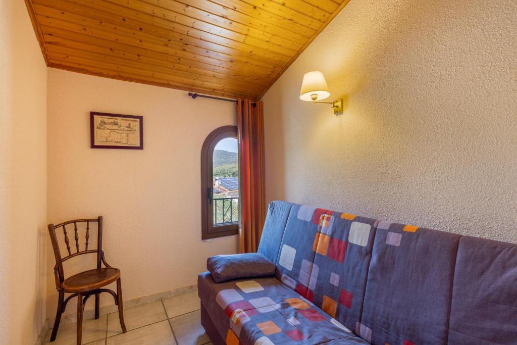 a living room with a couch and a chair at Els Castellers in Sant Pau dʼOrdal