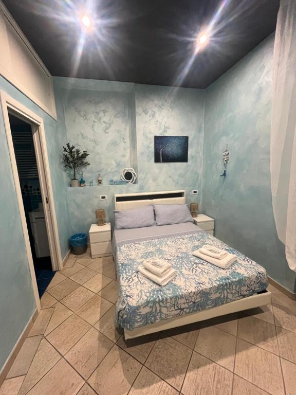 a bedroom with a bed with two towels on it at Il Corallo in Terracina