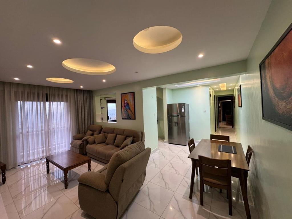 a living room with a couch and a table at JK properties in Kampala