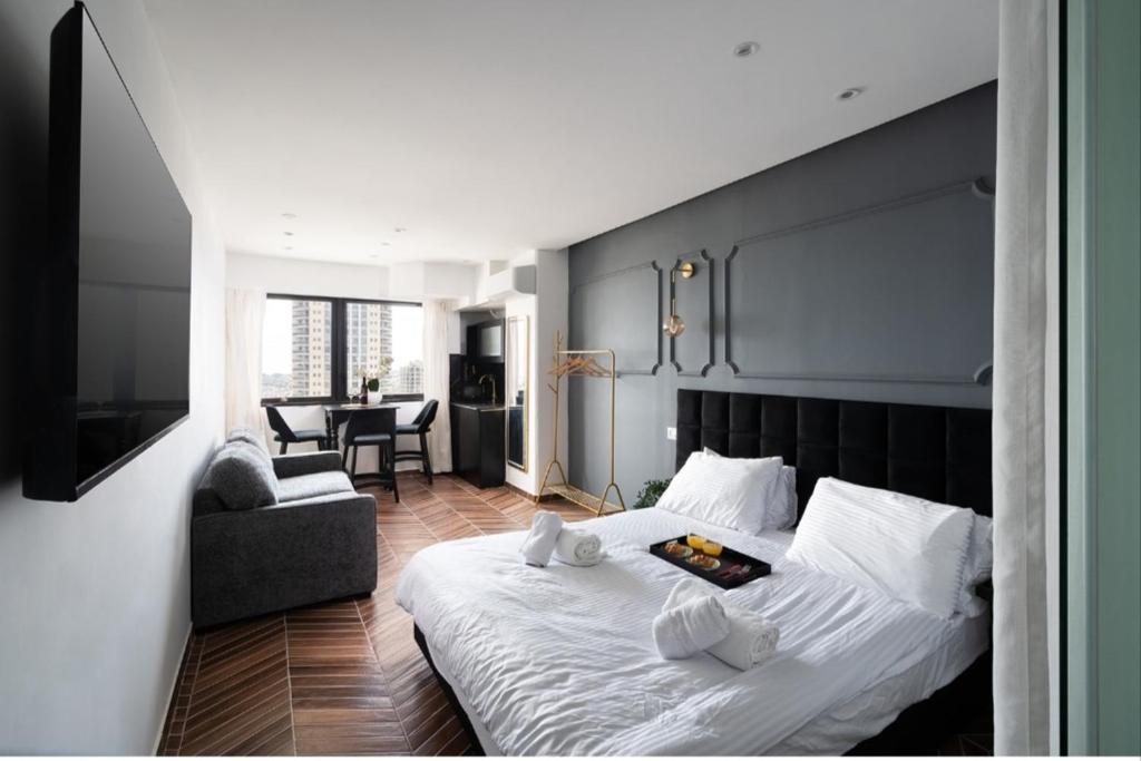 a bedroom with a large bed and a living room at City tower 16 floor in Jerusalem