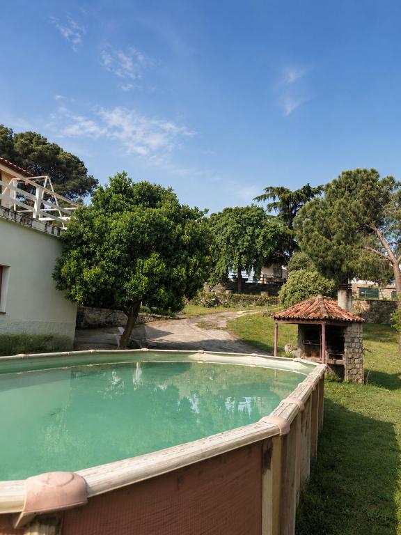 a swimming pool in a yard with a wooden fence at El Cerro del Pinar in Oropesa