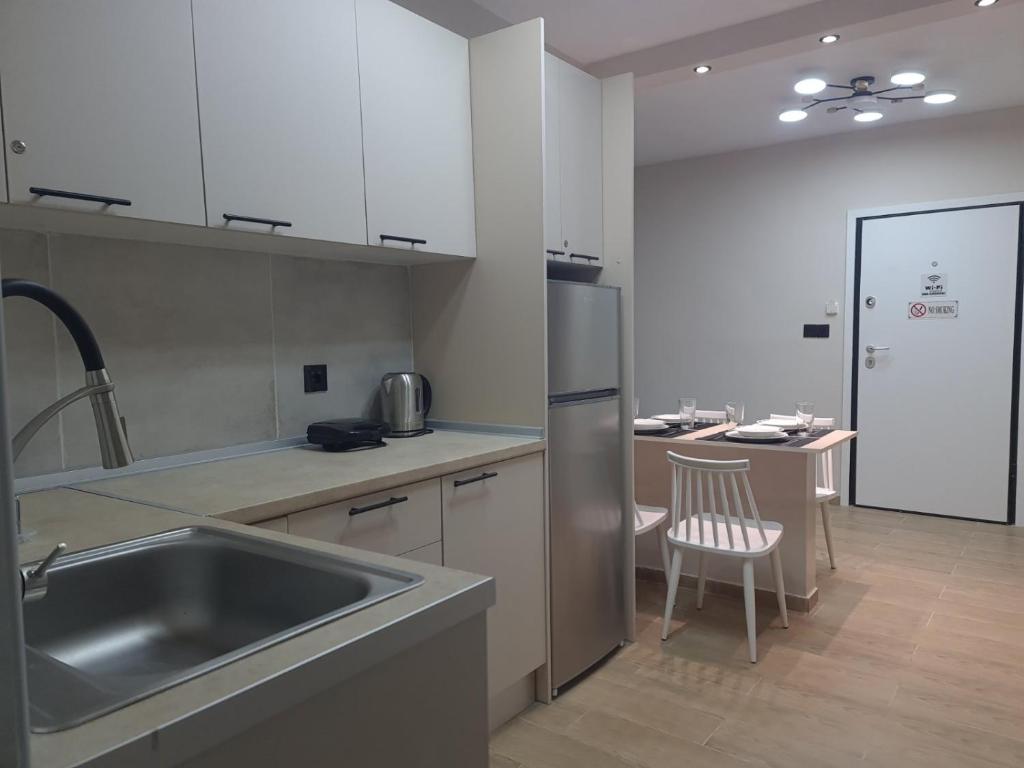 a kitchen with a stainless steel sink and a counter at Rhódia & Sun by Booking Kottas in Ixia