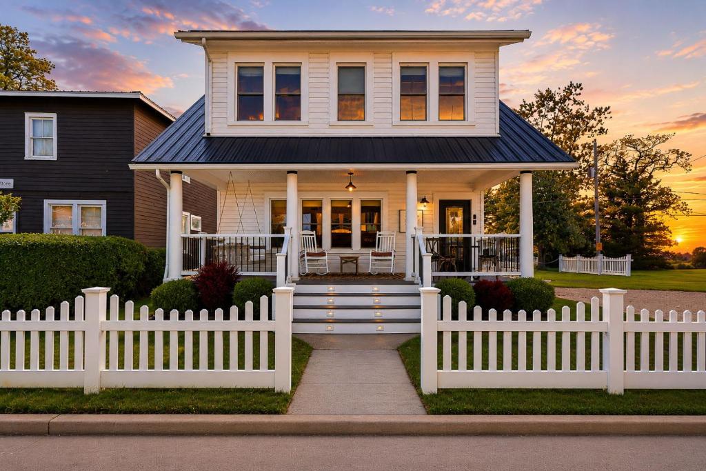 a white picket fence in front of a house at Dragonfly Guest House-GOTL Strip in Geneva