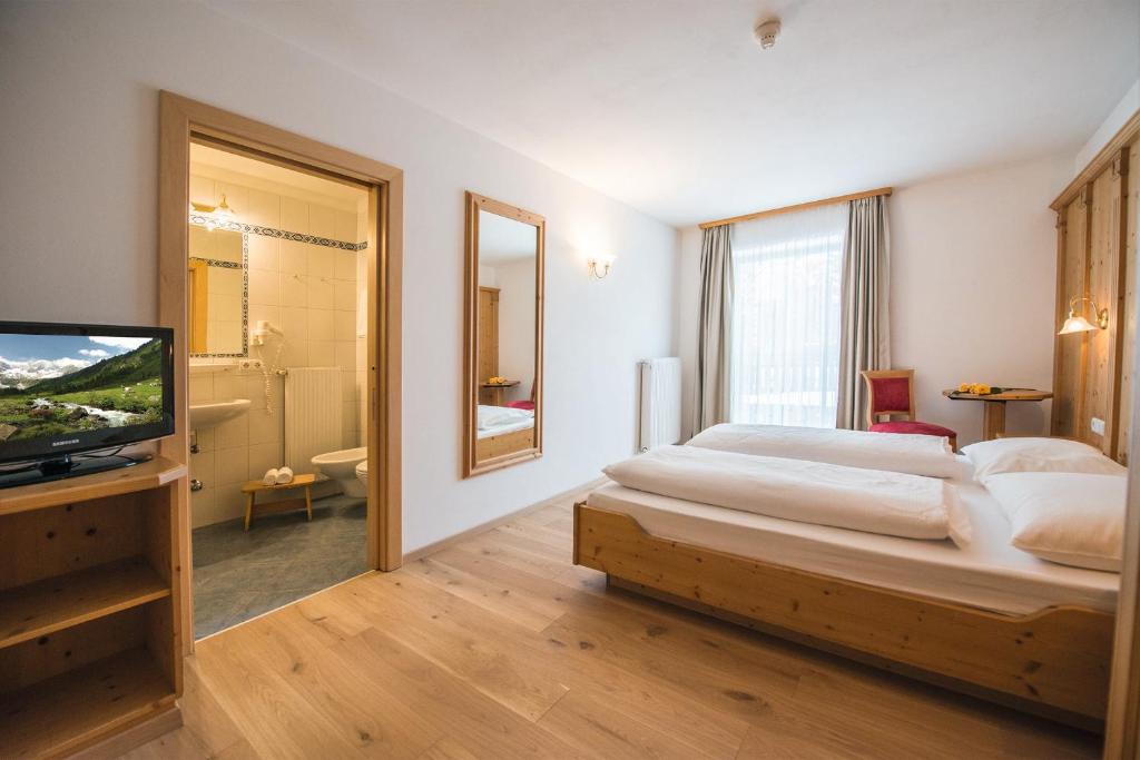 Postel nebo postele na pokoji v ubytování Hotel Obereggen