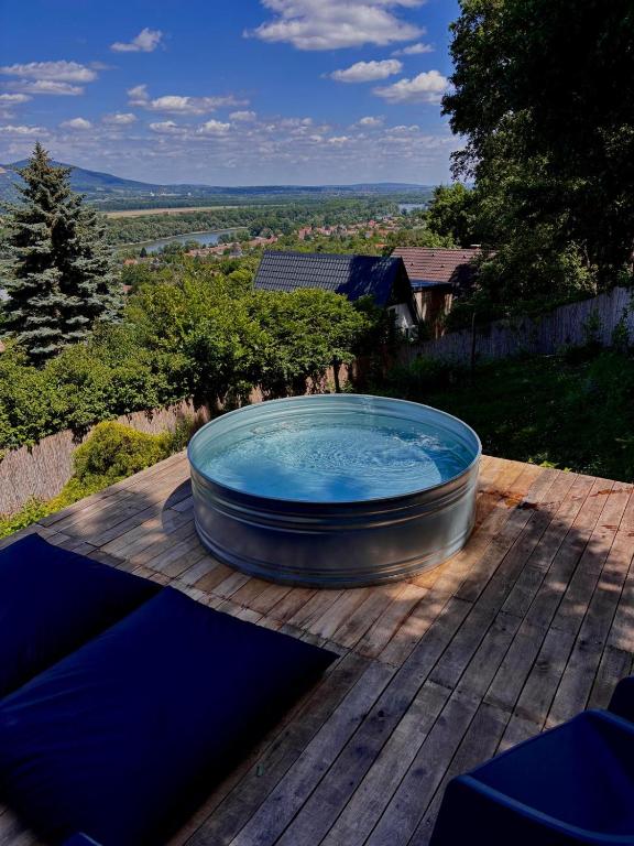 a hot tub sitting on top of a wooden deck at helloduna in Dunabogdány