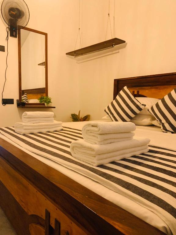 a bedroom with a bed with towels on it at jungle view in Nilwella