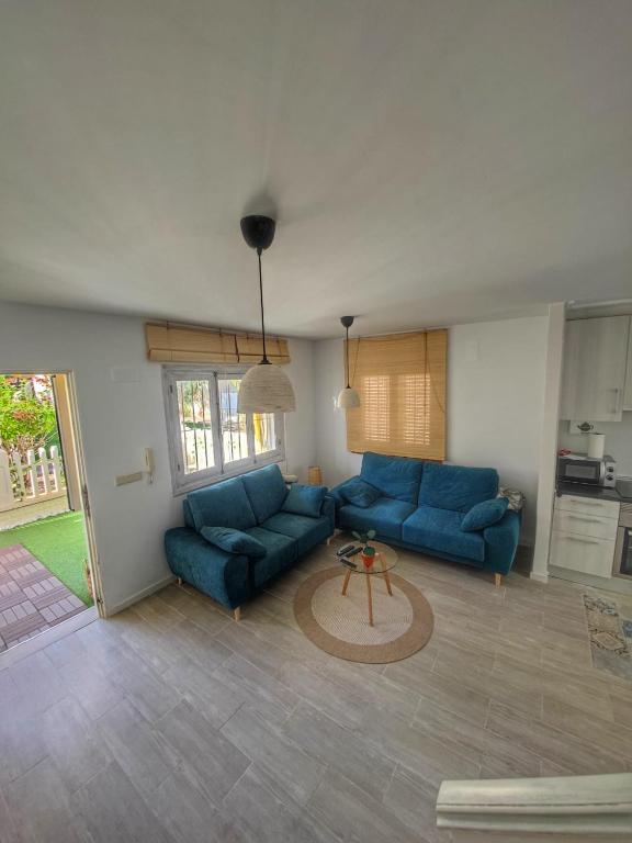 a living room with two blue couches and a table at Relaxing & Cozy House in Gran Alacant