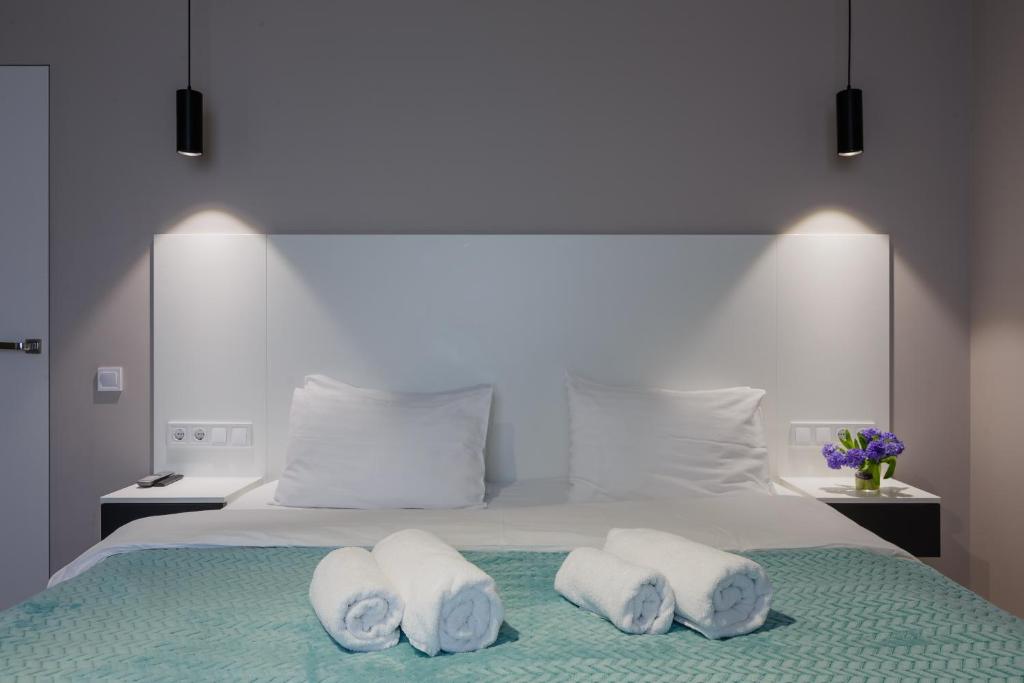 a bedroom with a bed with towels on it at Вікторі Апарт in Kyiv
