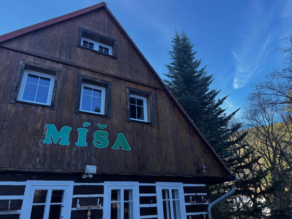 a wooden building with the word mica on it at Pension MÍŠA in Velká Úpa