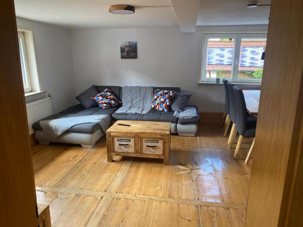 a living room with a couch and a table at NEU! Ferienwohnung Bruno in Gersfeld