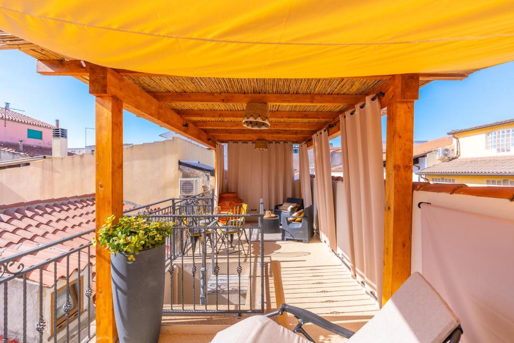 a large yellow canopy on the balcony of a building at PV9 by DomusAway in Olbia