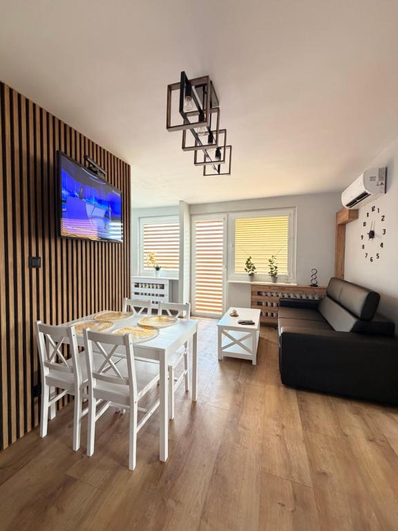 a living room with a white table and a couch at Apartament Ryki in Ryki