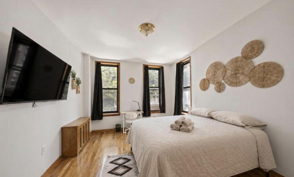a bedroom with a bed with a teddy bear on it at The NYC Value Room near Times Square & Broadway - Private Room with shared bathroom in New York