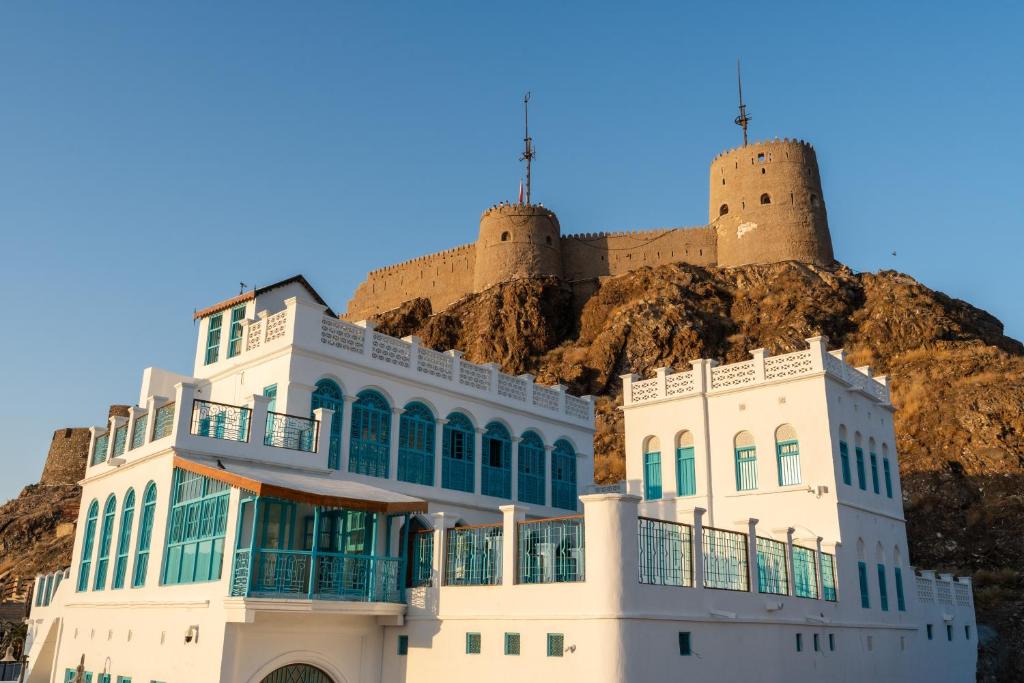 a building with two towers on top of a mountain at Al Bait Al Sharqi in Muscat
